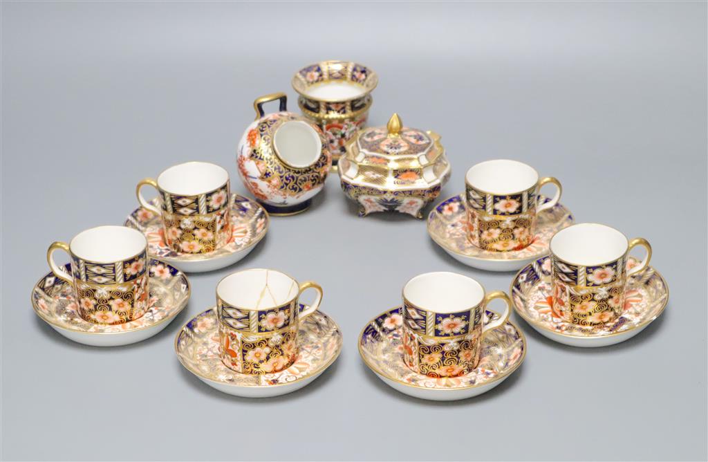 A Royal Crown Derby part tea service, pattern no. 2451, a similar vase and a sugar scuttle (faults)